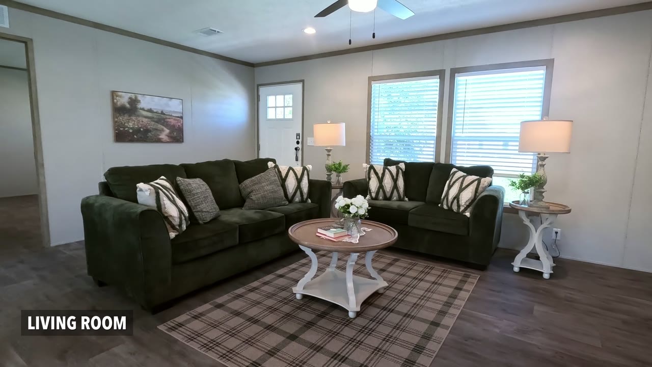 Frame from a walkthrough video: living room with a room label