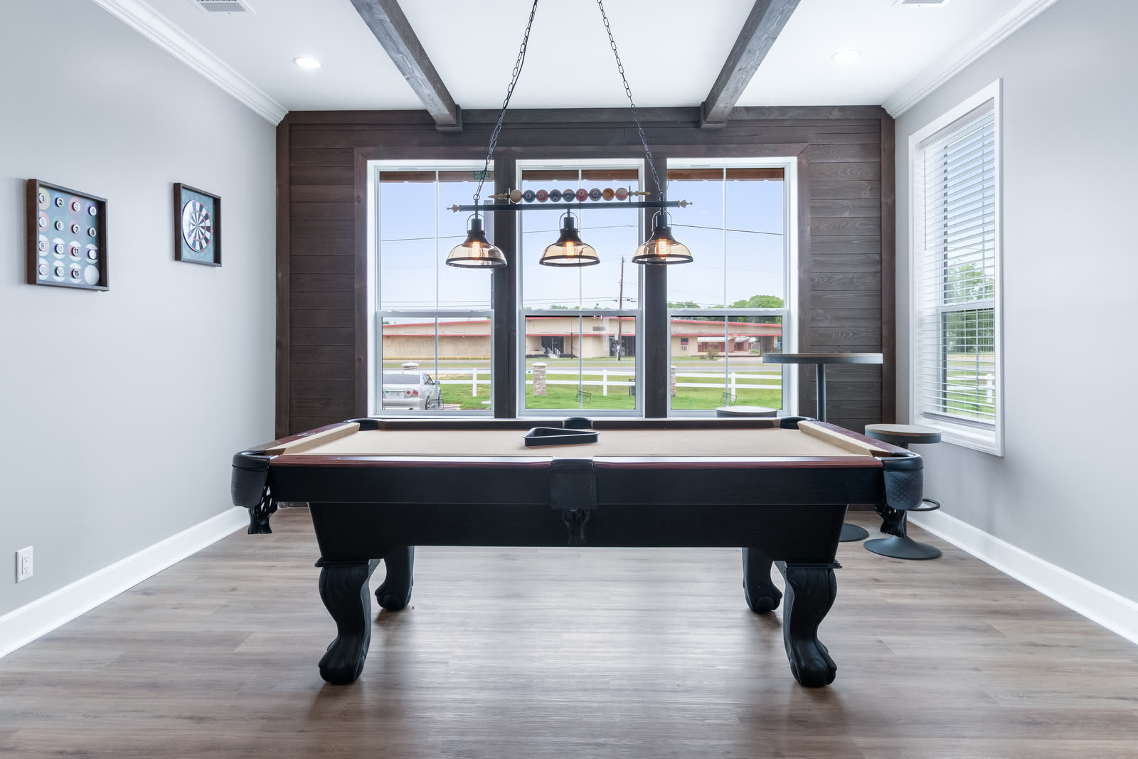 Game room with a pool table and pendant lights