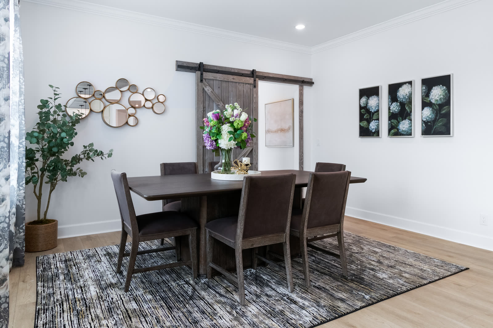 Dining room beside a sliding barn door